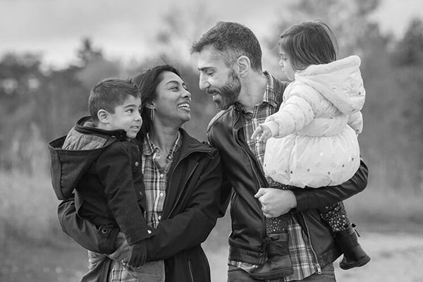 photo of mom and with their two kids walking on a fall day taken by a toronto family photographer