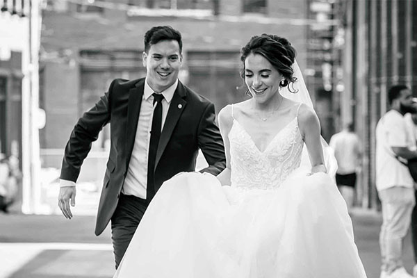 groom chases after bride on their wedding day as captured by a wedding photography studio in Toronto